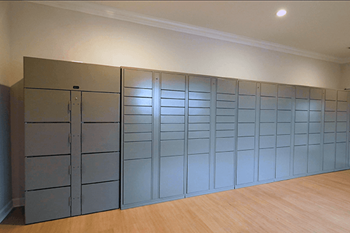 A room with a wall of cupboards and a wooden floor.