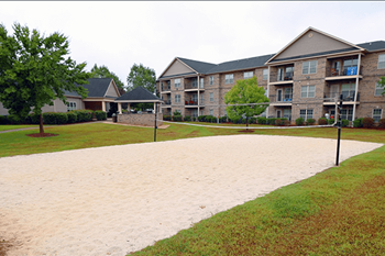 A sandy area in front of apartment buildings.