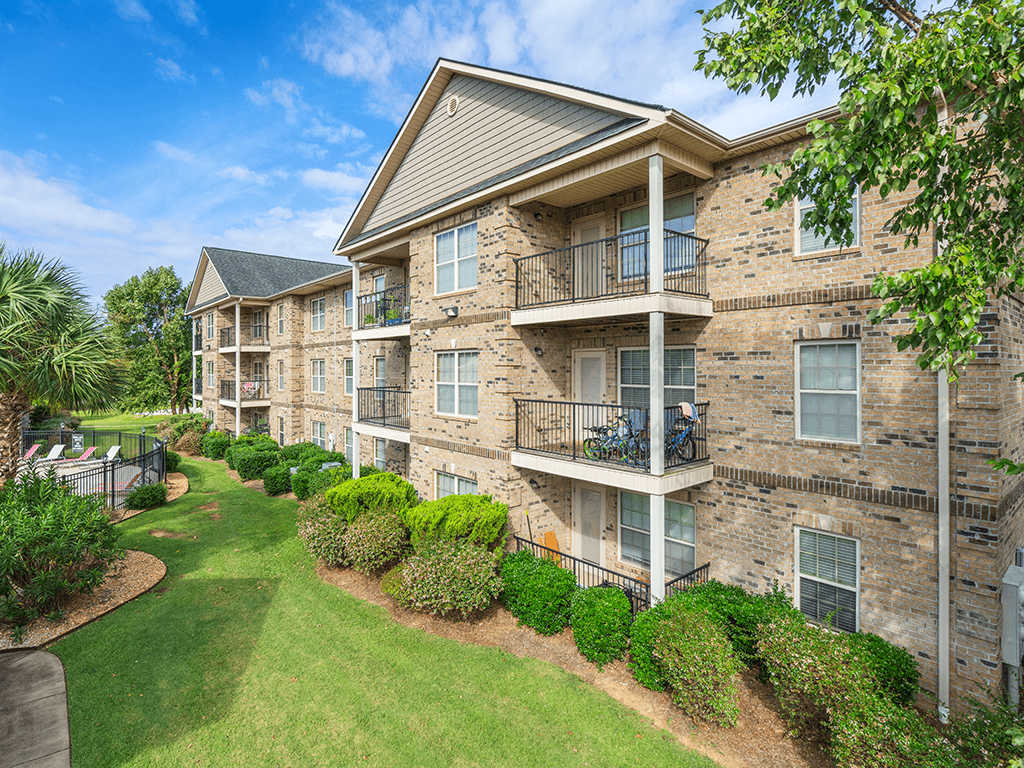 Apartment building with a green lawn in front.