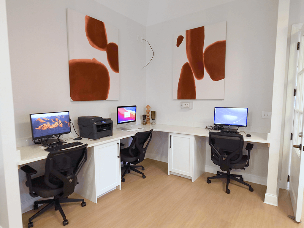 A room with two desks and two chairs.