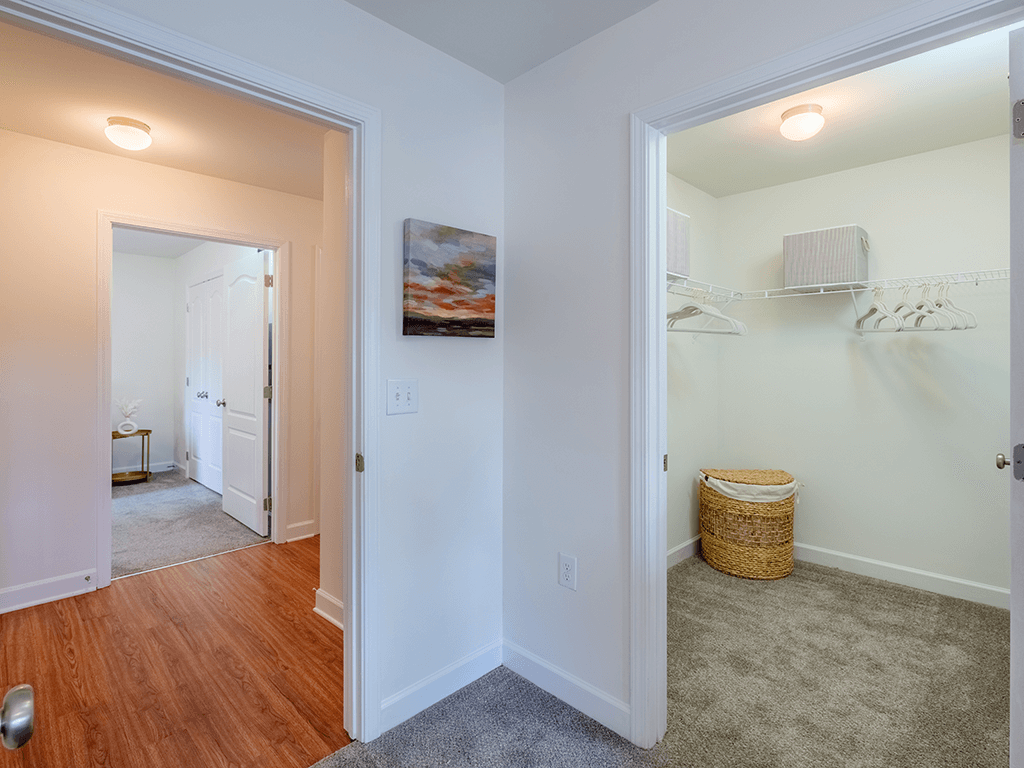 A room with a white door and a basket on the floor.