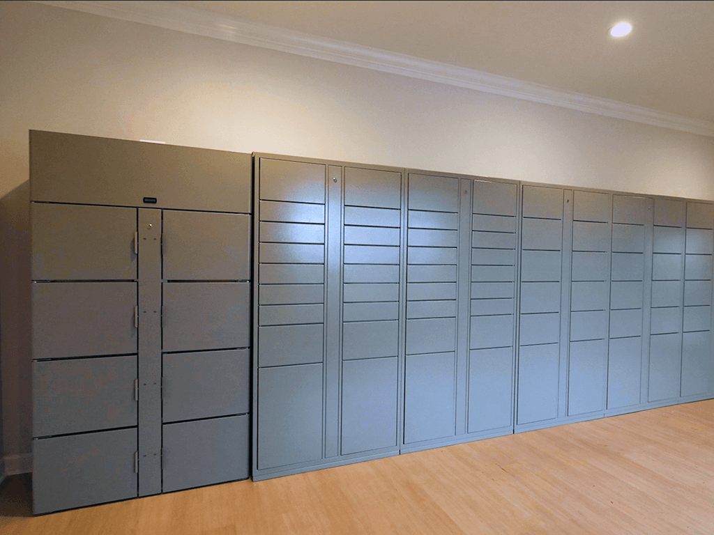 A wall of grey lockers in a room.