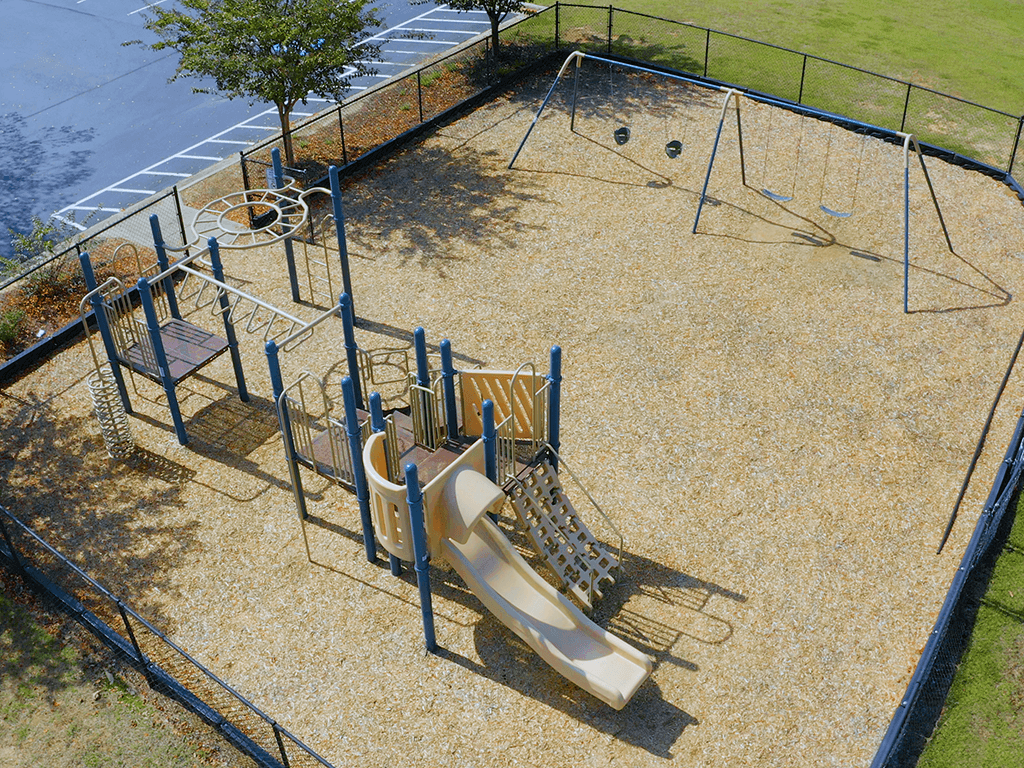 A playground with a slide, swings, and a climbing frame.