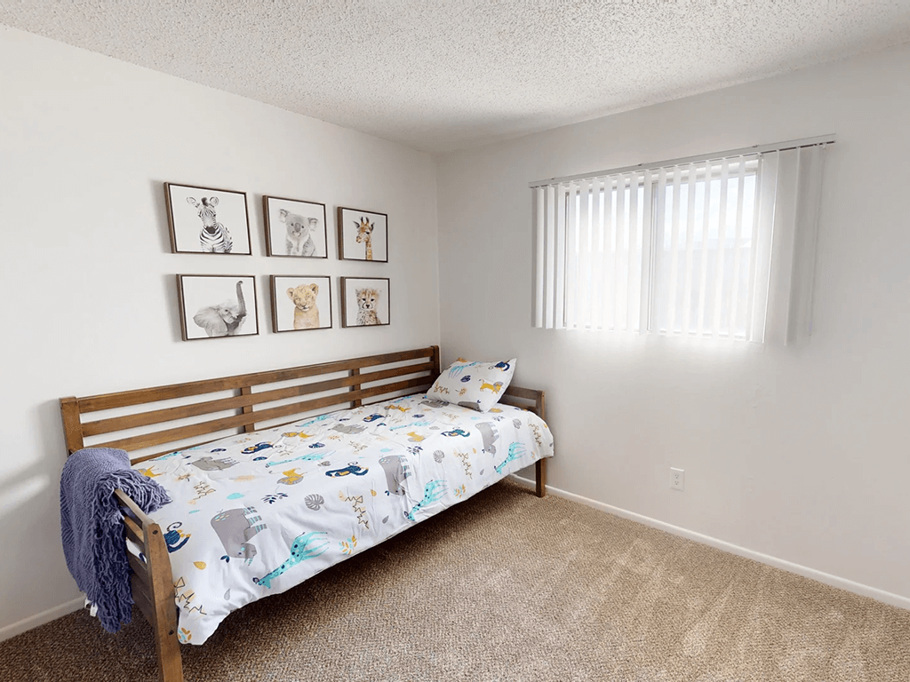 a bedroom with a bed and a window