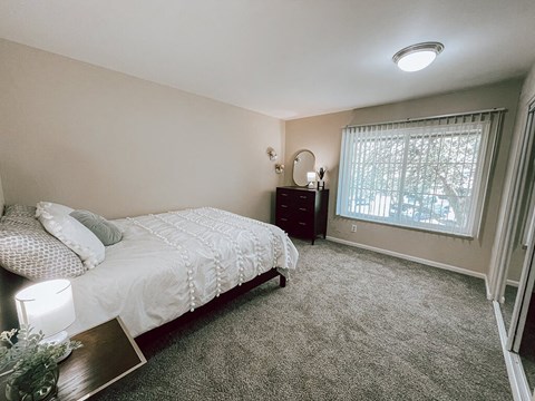 a bedroom with a bed and a window