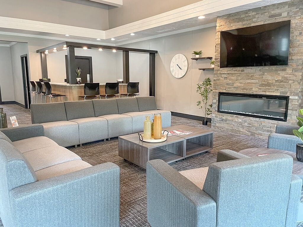 a apartment community clubhouse with couches and a television