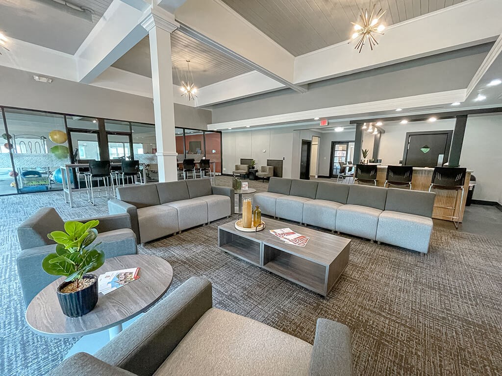 a large clubhouse room  with couches and a table