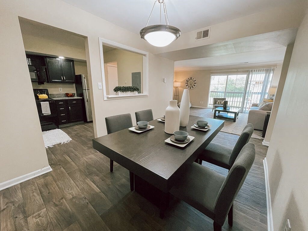 a dining room and living room with a table and chairs