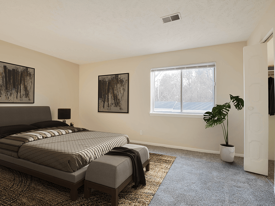 a bedroom with a large bed and a large window