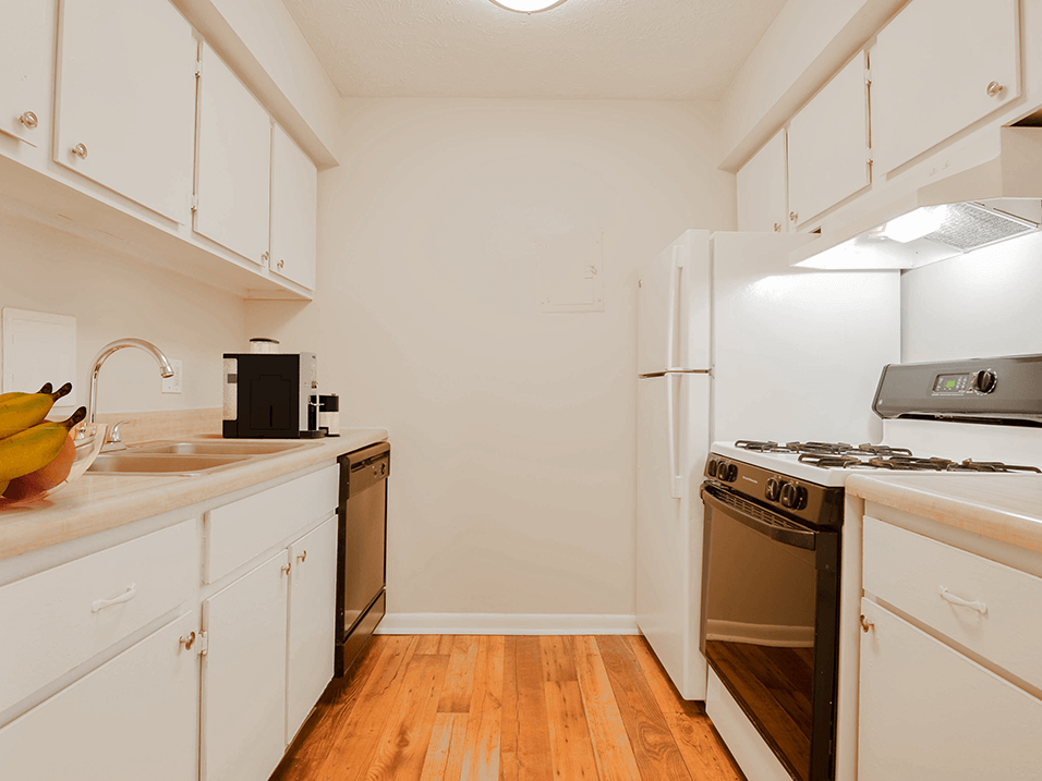 a kitchen with white cabinets and stainless steel appliances