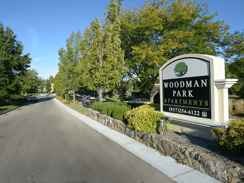 welcome sign at Woodman Park Apartments - Photo Gallery 1