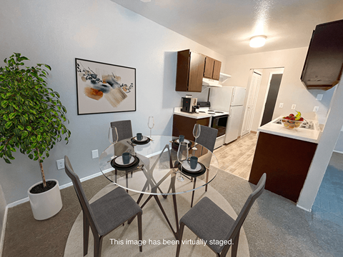 a kitchen and dining room with a glass table and chairs