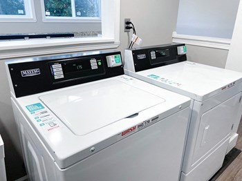 a washer and dryer sit next to each other in a laundry room - Photo Gallery 13