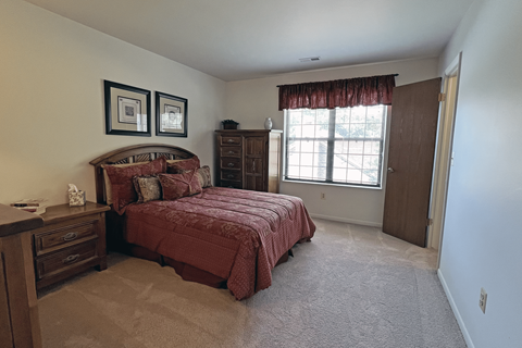 A bedroom with two beds and a dresser.