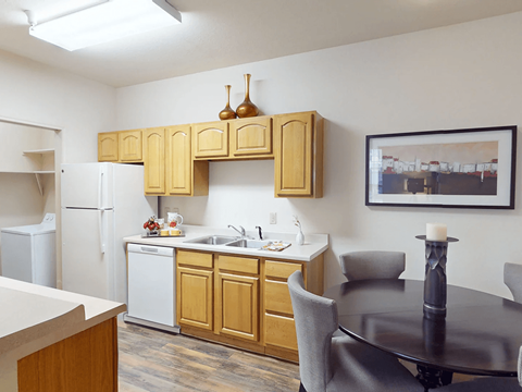 A kitchen with wooden cabinets and a black table.