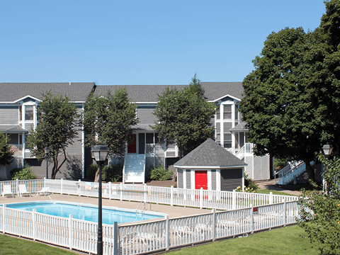 a swimming pool in front of an apartment building