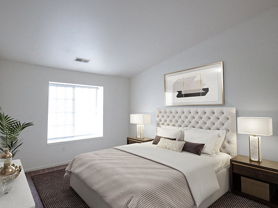 a bedroom with a bed and a large window