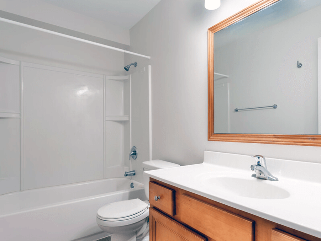 A white bathroom with a toilet, sink, and bathtub.