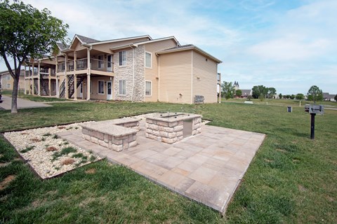 A large building with a stone fireplace in front of it.