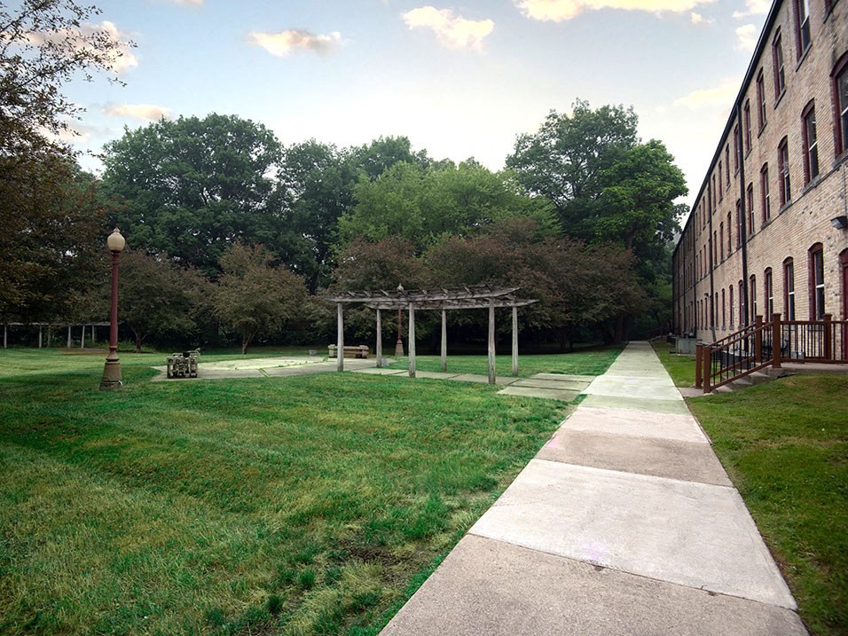a grassy picnic area with a building