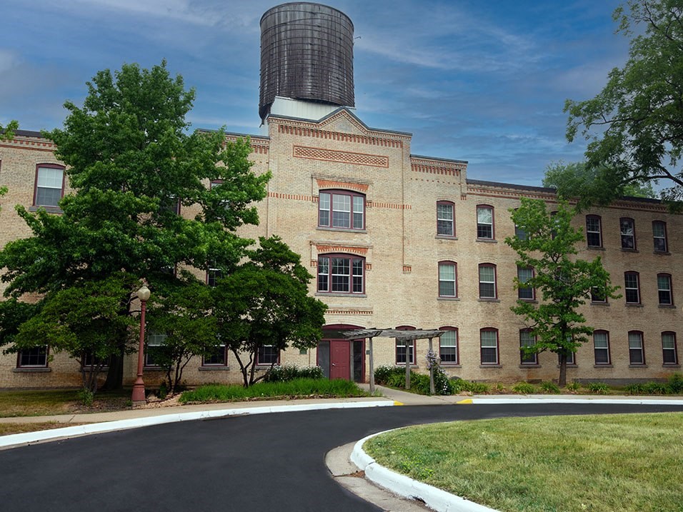 a large brick building with a silo on top