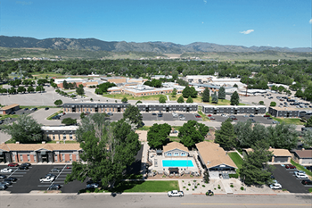 A large building complex with a swimming pool in the middle.