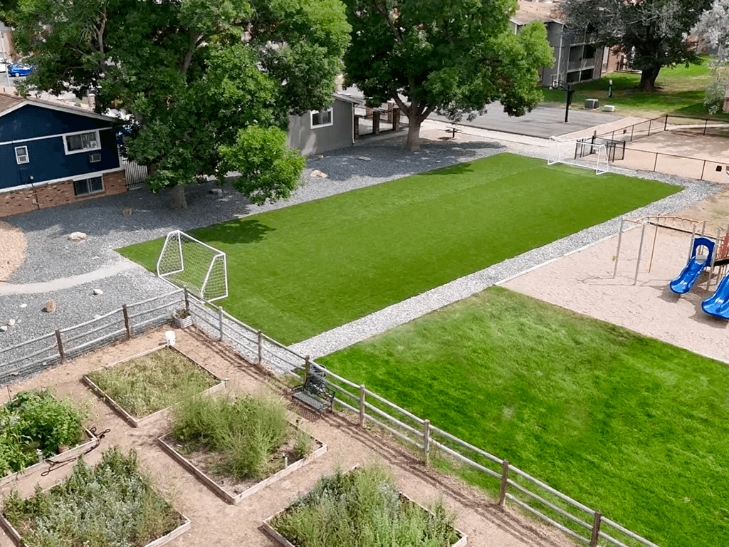 A soccer field with a goal in the middle of it.