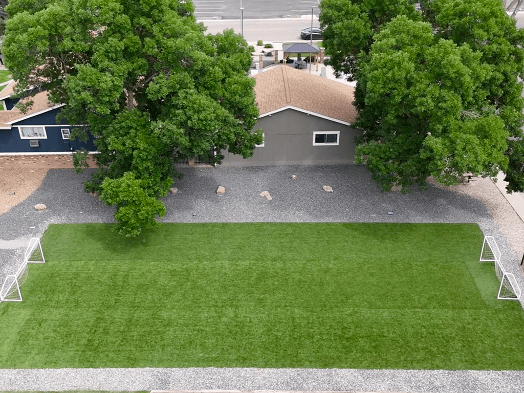 A house with a grey roof and a green lawn.