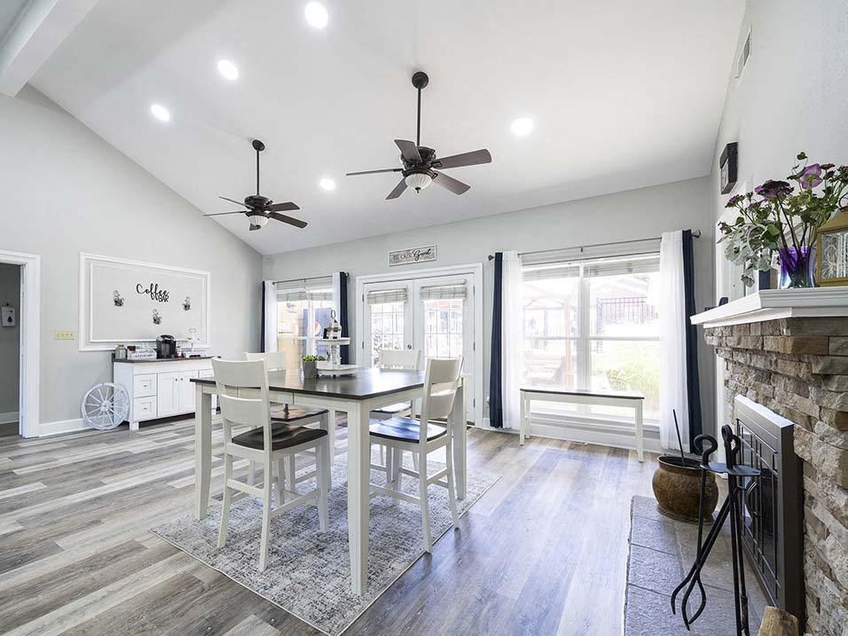 a dining room with a table and chairs in front of a fireplace