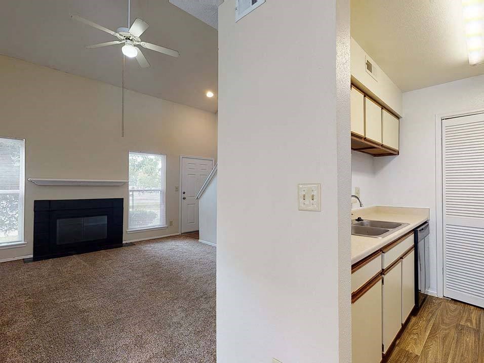 a kitchen and living room with a fireplace