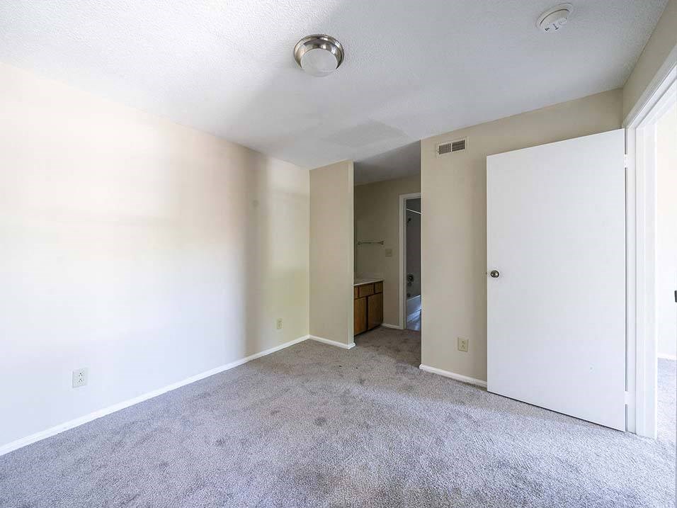 an empty living room with white walls and a white door