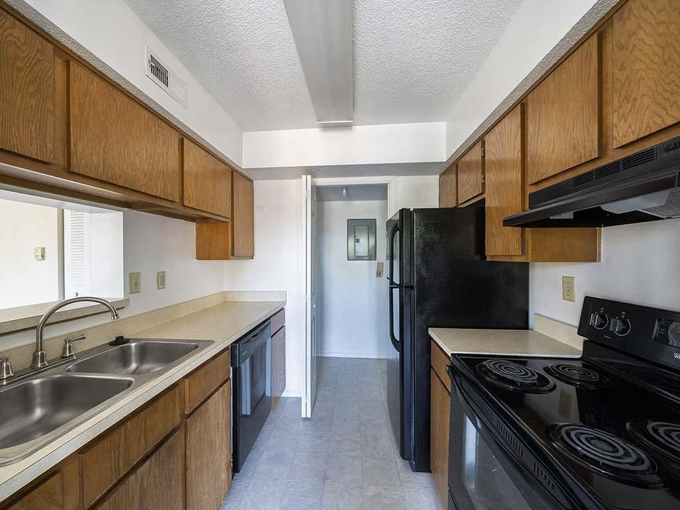 a kitchen with a black stove and a black refrigerator