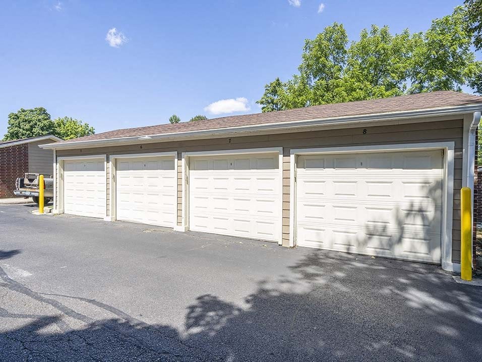 a garage with white doors in a parking lot