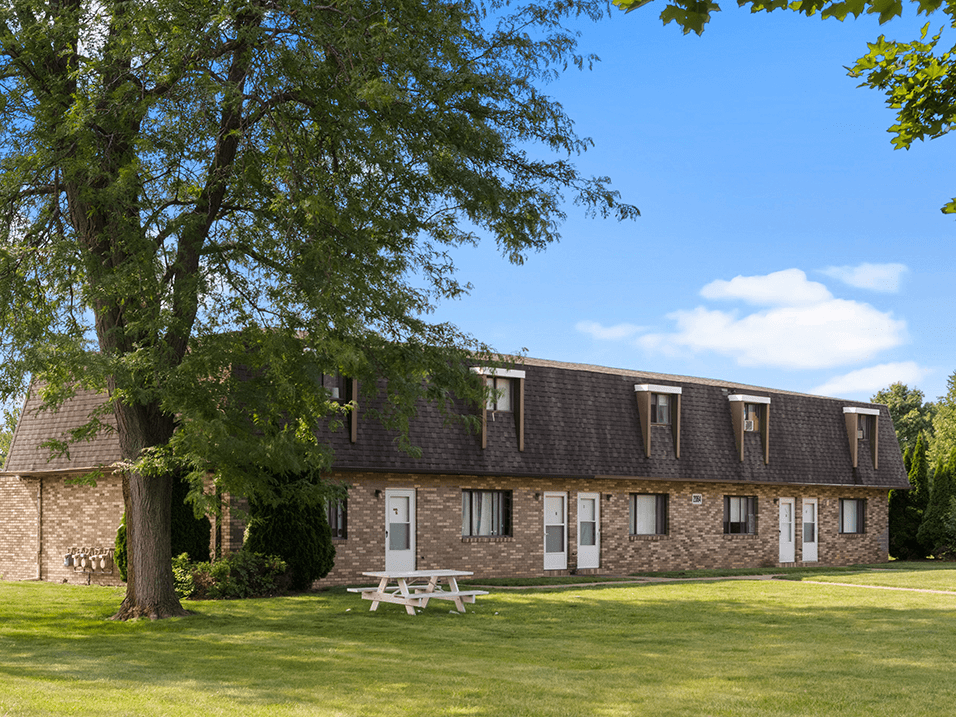 an brick building under a shade tree
