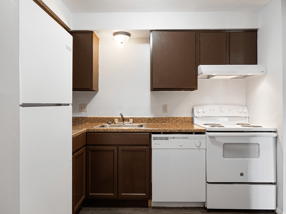 a kitchen with white appliances and a counter top