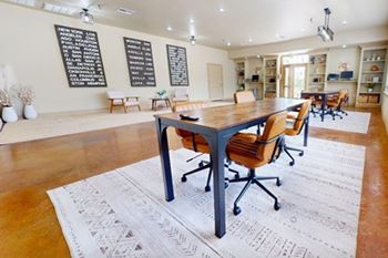A conference room with a long table and chairs.
