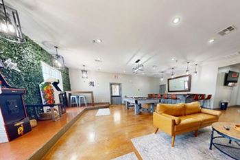 A living room with a green wall and a wooden floor.