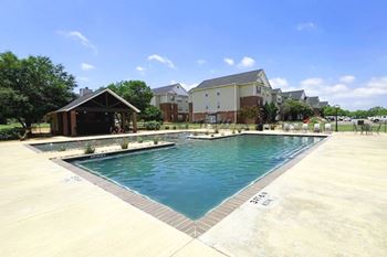 A swimming pool with a building in the background.