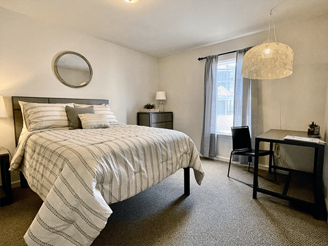 bedroom with window and space for a desk