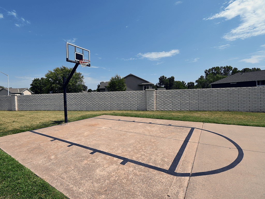 A basketball court with a hoop and a backboard.
