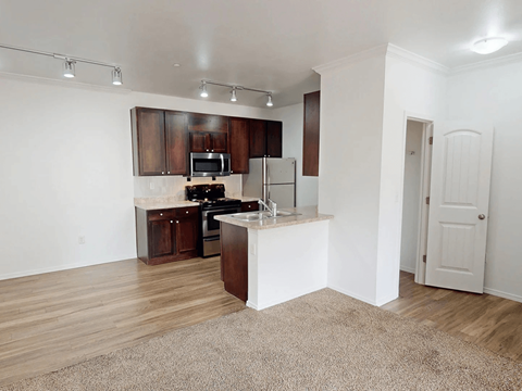 A kitchen with wooden cabinets and a white island.
