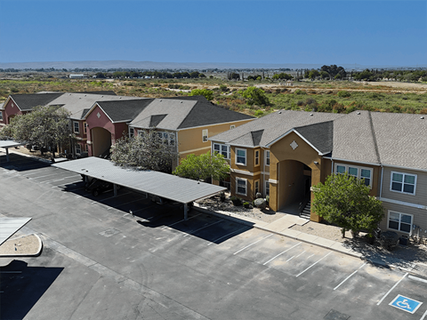 A parking lot with a building in the background.