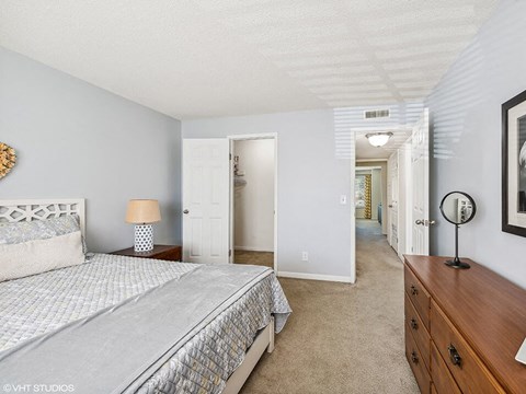 a bedroom with a bed and a walk-in closet