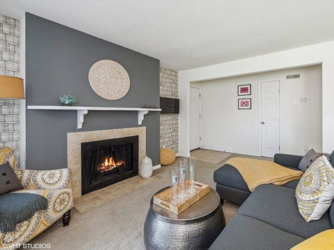 a living room with a fireplace and couches