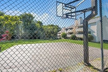 a basketball court is shown behind a chain link fence