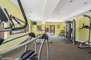 a gym with weights and other equipment in a building