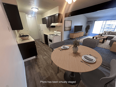 A modern kitchen with a dining table and chairs.