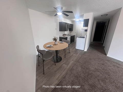 A photo of a living room with a dining table and chairs.