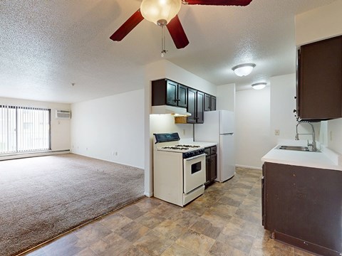 A kitchen with a white oven and a brown counter.