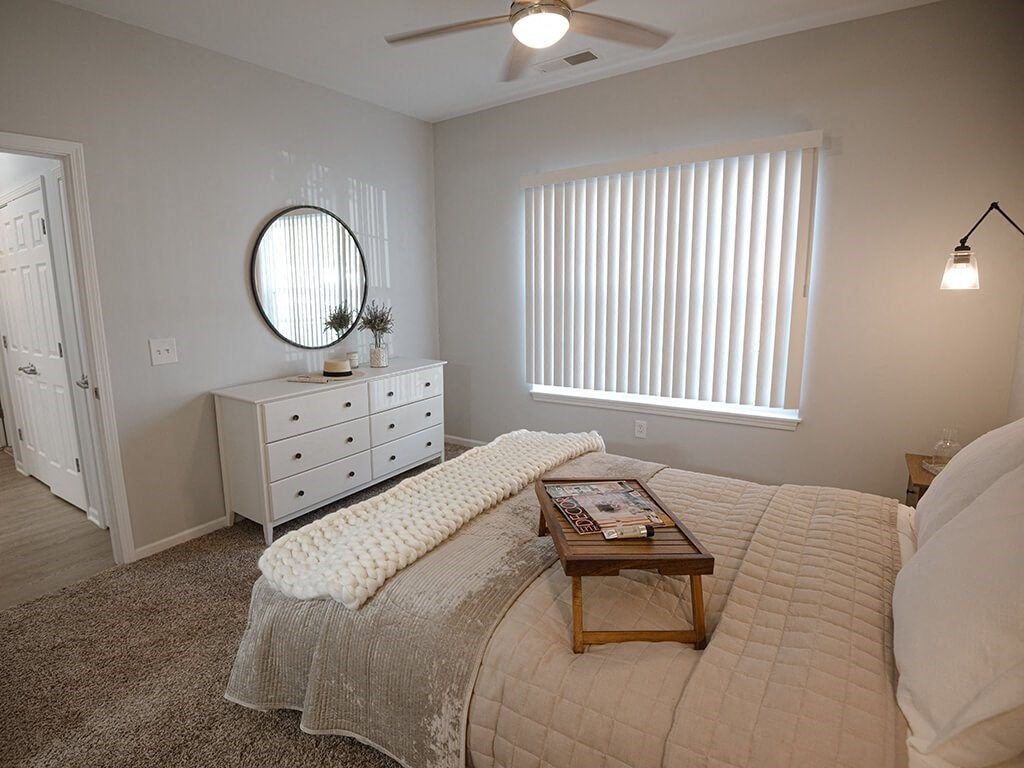 bedroom with carpet and a window